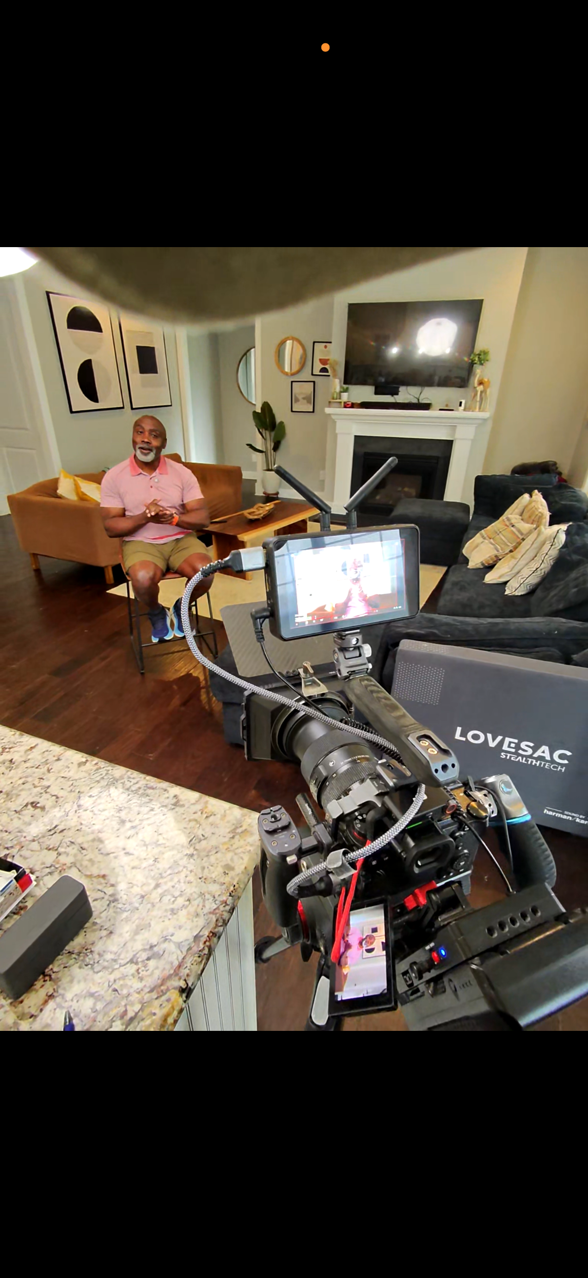 Behind-the-scenes camera setup while filming Peter Mutabazi indoors.
