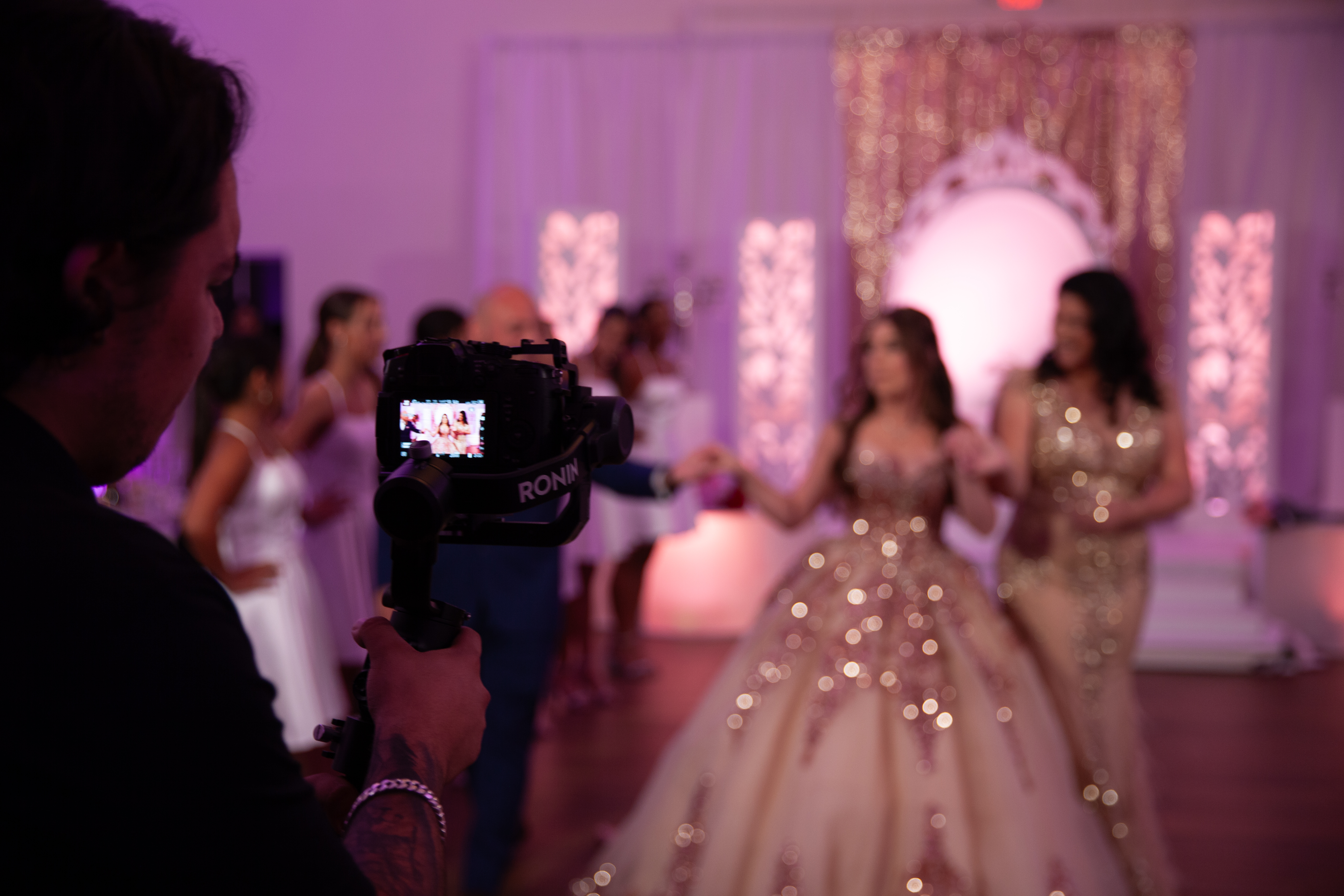 Filming a quinceanera event with a handheld camera and gimbal.