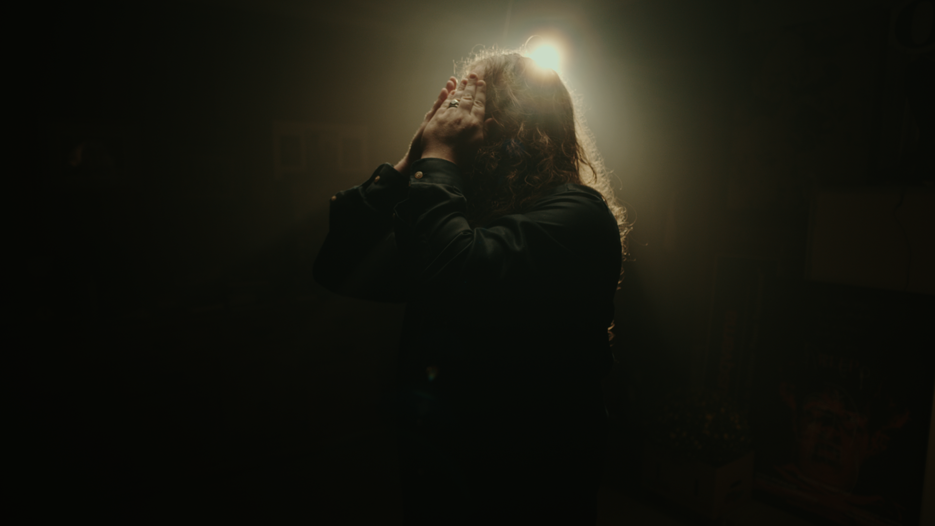 A supplied frame from The Way Things Settle, with a person lit from behind.